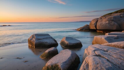 Coastal landscape with smooth rocks at low tide during sunset with soft waves and pastel sky colors in the background