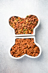Bone-shaped bowl of dog food. Top view.