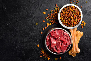 Dog food. Bowl with fresh meat and bowl with dry pet food. Healthy food for animals.