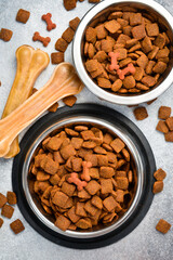 Metal Bowl with pet food. Organic grain food for dog or cat with meat flavour. Top view.
