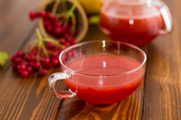 tea from ripe red viburnum on a wooden table