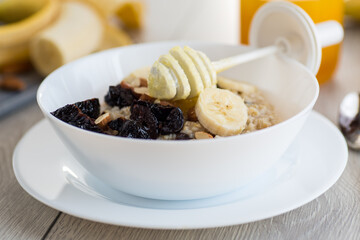 Healthy and nutritious breakfast with oatmeal and honey