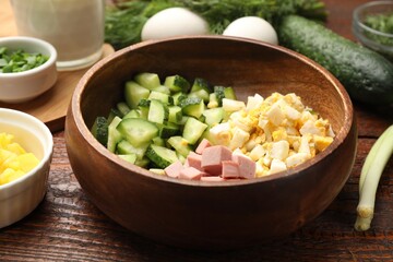 Different ingredients for okroshka soup on wooden table, closeup