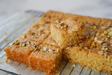 Eggless Semolina or Rava cake topped with nuts, selective focus