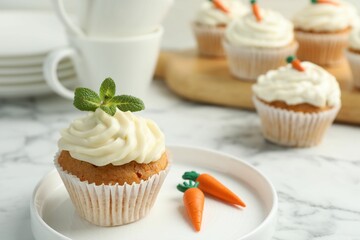 Delicious carrot cupcake with mint on white marble table, closeup