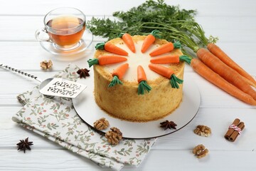 Delicious homemade carrot cake served on white wooden table