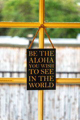Inspirational message of aloha displayed in a sunny interior setting 