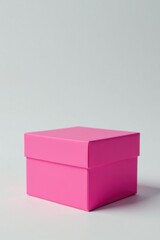 Fototapeta premium A Vibrant Pink Gift Box Ready for a Special Occasion on a Neutral Background