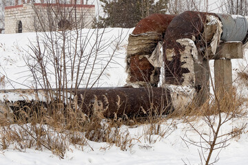 Overground heat pipes. Pipeline above the earth conducting heat for heating city. A snowy winter day