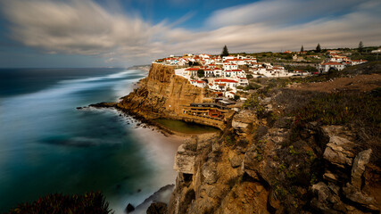 Azenhas do Mar, a seaside town in the municipality of Sintra, Portugal at sunset. The rocky coastline of the Atlantic Ocean. The Portuguese coast in the golden hour