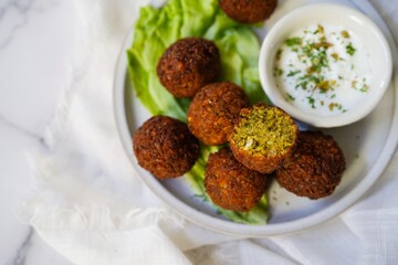 Homamade Falafel served with yogurt dip, selective focus