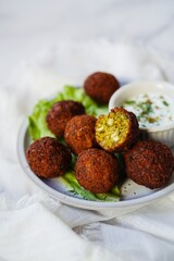 Homamade Falafel served with yogurt dip, selective focus