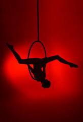 Aerial gymnastics. Gymnast on aerial hoop. Athlete trains on aerial hoop