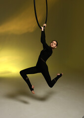 Aerial gymnastics. Gymnast on aerial hoop. Athlete trains on aerial hoop
