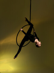 Aerial gymnastics. Gymnast on aerial hoop. Athlete trains on aerial hoop