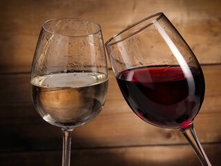 Red and white wine glasses on old wooden vintage background, close up, studio shot