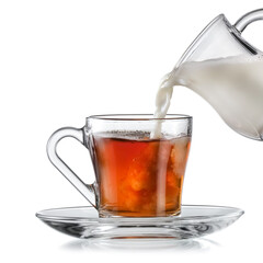 Milk pouring in a glass with hot tea on white background, studio shot