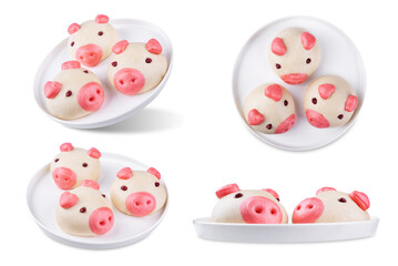 Steamed buns with custard filling in the form of pig in a plate on a white isolated background