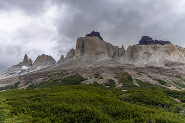 Torres del Paine national park mountain landscape in Patagonia, Chile. Los Cuernos and Torres del Paine peak granite towering summits on a nasty and sunny day above the blue water lake in the Andes