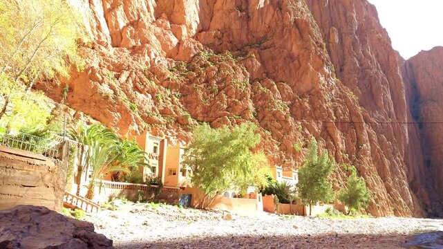 Scenic mountain gorge with steep rocky cliffs under a clear blue sky in Todra Gorge, Morocco