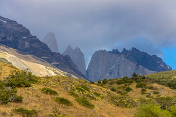 Torres del Paine national park mountain landscape in Patagonia, Chile. Los Cuernos and Torres del Paine peak granite towering summits on a nasty and sunny day above the blue water lake in the Andes