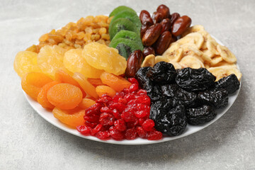 Mix of different dried fruits on grey table, closeup