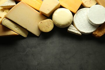 Different types of cheese on grey table, flat lay. Space for text