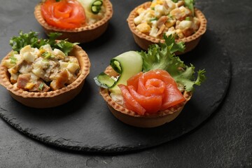 Tartlets with delicious fillings on black table, closeup