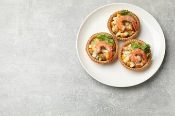 Tartlets with delicious filling on grey table, top view. Space for text