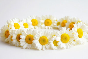 Obraz premium A top view of wild yellow and white flowers arranged around an empty space for text, framed naturally with a white background, offering a fresh, minimalistic vibe