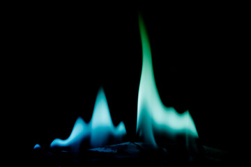 Colorful Flames in Dark Background Displaying Blue and Green Hues