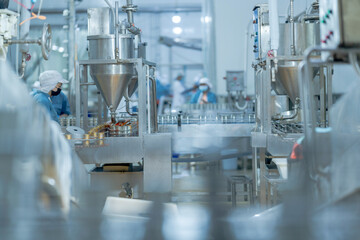 Food production workers handling fish for canning on an automated conveyor system Highlights of precision and quality assurance in industrial workflows.