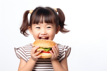 Cute little asian girl enjoy eating a hamburger have fun child food cute.