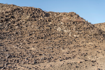 rocky slope with sparse vegetation, near De Riet, Namibia