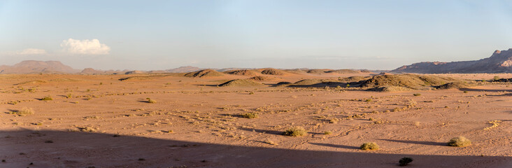 long shadows on sandy desert and little hills from above, near Twyfelfontein, Namibia