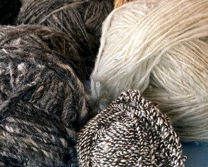 A collection of yarn balls of different colors and textures