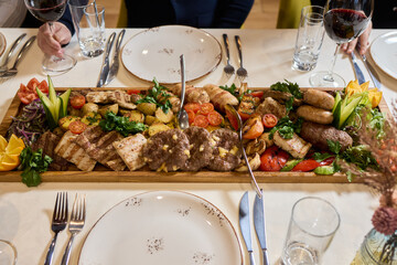 Indulge in an exquisite gourmet platter perfectly paired with a fine red wine selection