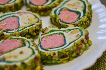 plate of beautiful Turkish sweet roll slices pistachios homemade gourmet culinary Middle Eastern Mediterranean desserts confectionery unique appetizers healthy exotic cuisine traditional lokum treats