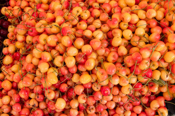 a market with fresh cherries, fruits and vegetables at a farmer's market on a background of cherry berries