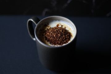 black cup of coffee with hot milk 