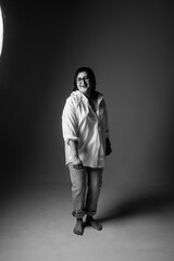 Portrait of a young beautiful plump short-haired girl in the studio. Black and white photo.