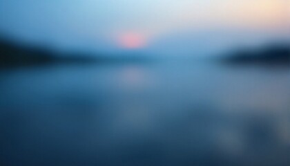 Fototapeta premium The image appears to be an out of focus sunset over water.