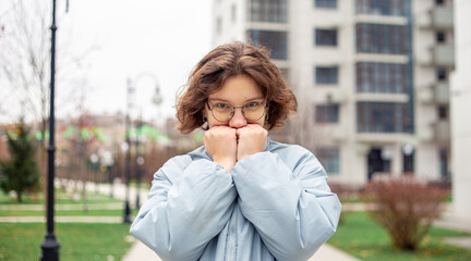 Freezing woman. A young beautiful frozen girl suffers from cold weather.