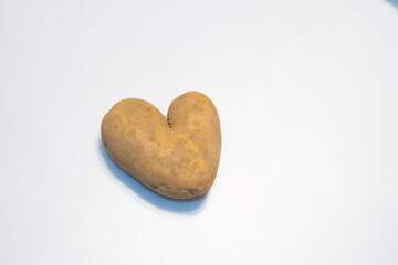 heart shaped potato on wooden table