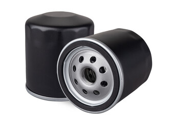 Two black oil filters are positioned isolated on white background. highlighting their metal construction and circular openings used for engine oil filtration. car spare part and service concept.