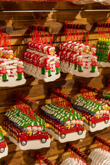 Colorful Christmas ornaments hanging on wooden display near New Year