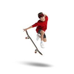 Fototapeta premium Cute little boy with skateboard in air on white background. Performing trick