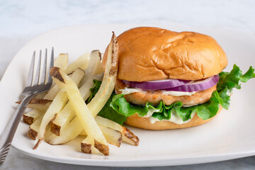 salmon burgeron a brioche bun with fries