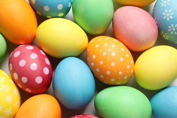Beautiful decorated Easter eggs on light background, top view