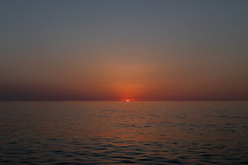 sunset on the background of the sea sky, Sunset sky, clouds over the sea in the evening with orange, yellow sunlight, Golden hour